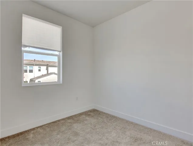 a view of a hallway with wooden floor and closet