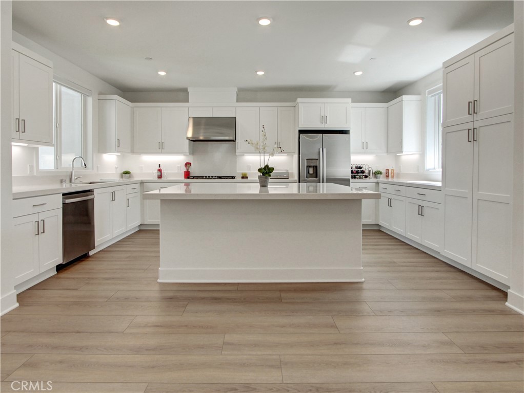 230 Sora Irvine, CA 92618 - Photo 5 of 52 a large kitchen with cabinets wooden floor and stainless steel appliances