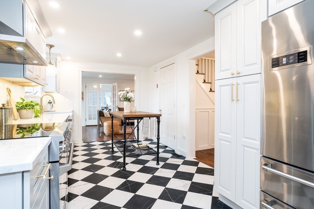 1051 Chesterfield Road Northampton, MA 01062 - Photo 19 of 42 a kitchen with a refrigerator a microwave and a dining table