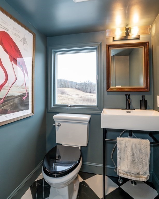 1051 Chesterfield Road Northampton, MA 01062 - Photo 22 of 42 a bathroom with a toilet a sink and a mirror