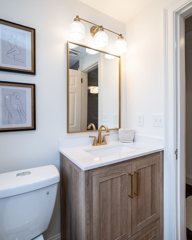 1051 Chesterfield Road Northampton, MA 01062 - Photo 35 of 42 a bathroom with a toilet a sink and mirror
