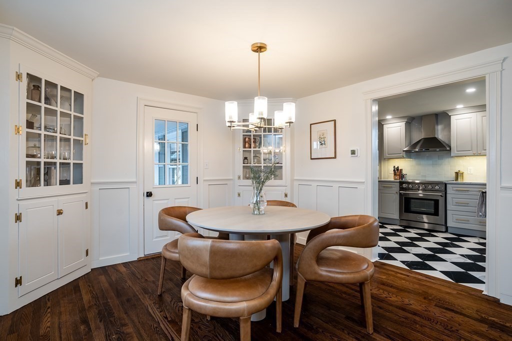 1051 Chesterfield Road Northampton, MA 01062 - Photo 6 of 42 a dining room with wooden floor a chandelier a wooden table and chairs