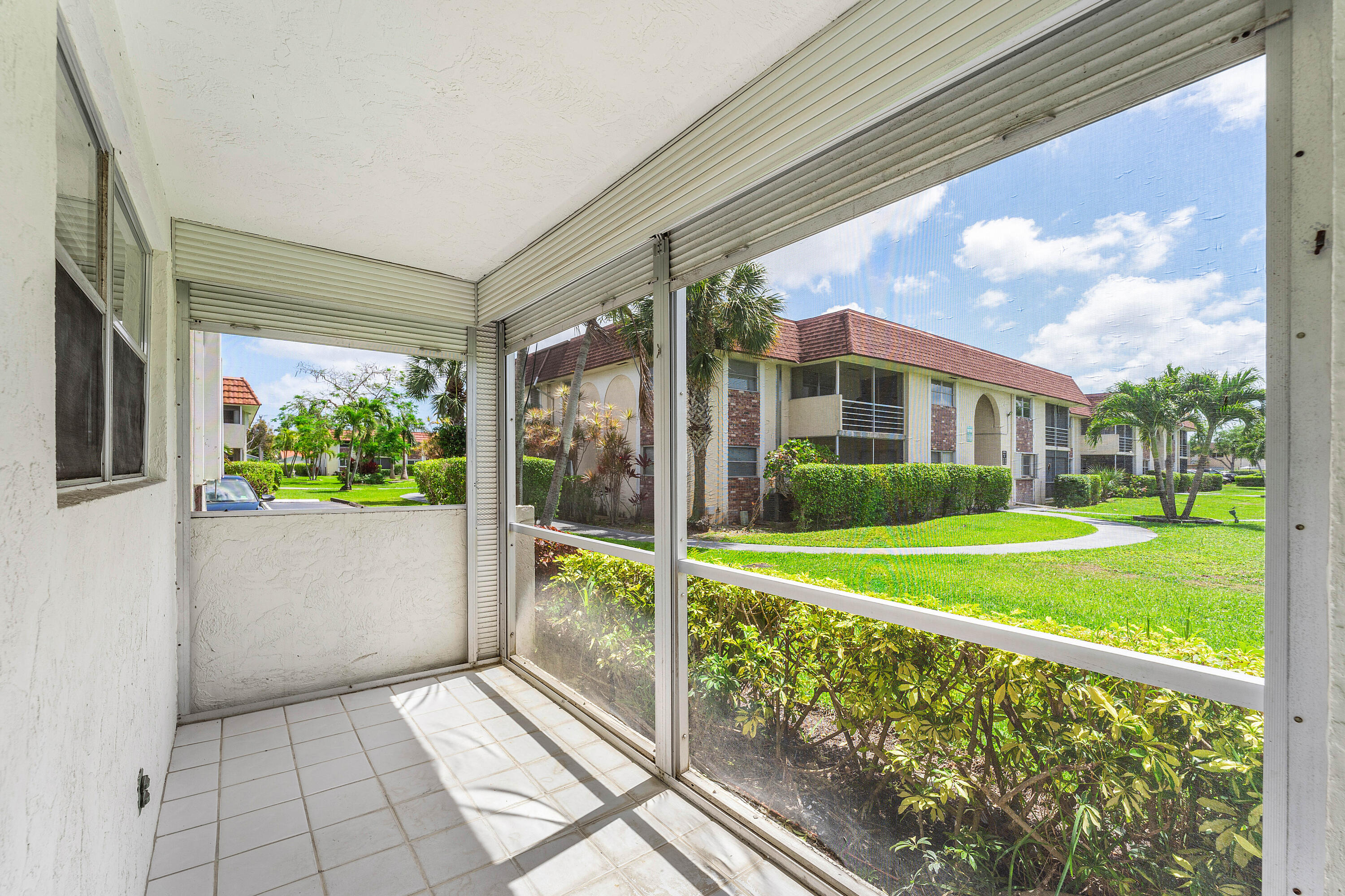 22725 Southwest 66th Avenue, Unit 103 Boca Raton, FL 33428 - Photo 7 of 14 Living Area – Natural Light & Patio Acce
