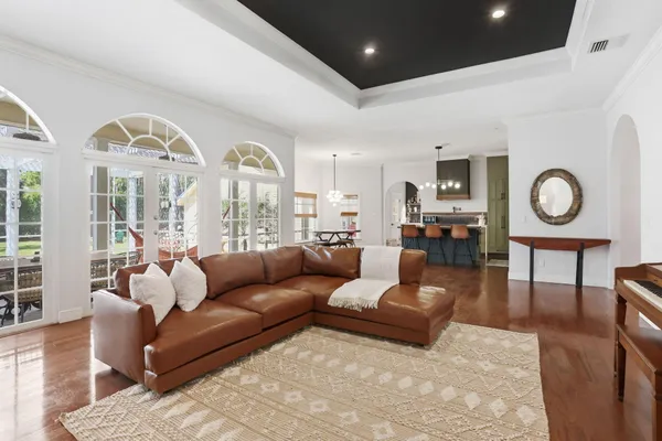 a view of a bedroom with furniture and chandelier