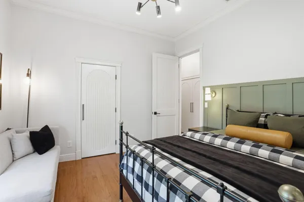 a front view of a house with a garden and outdoor seating