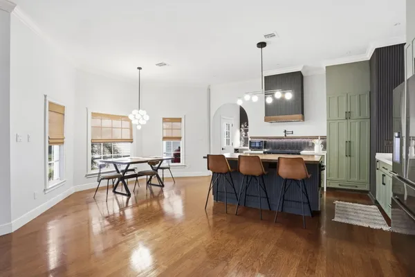 a large kitchen with a table and chairs