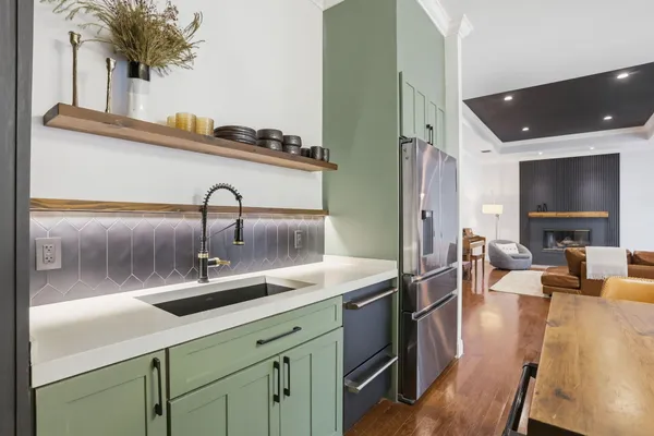 a kitchen with a refrigerator and a sink