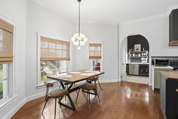 a living room with furniture fireplace and large windows
