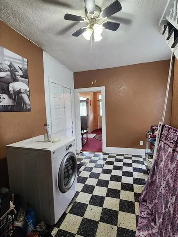 a view of a workspace with furniture and a rug