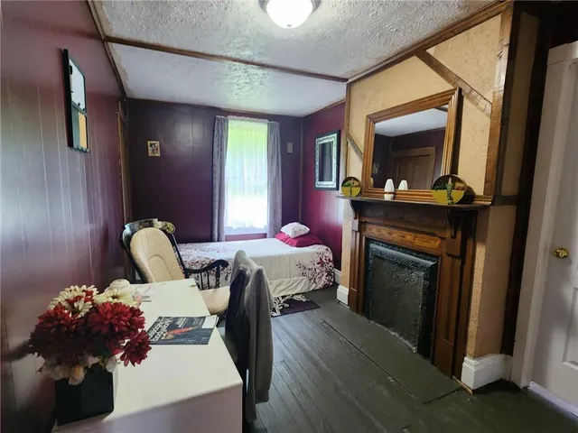 a bedroom with a bed and a fireplace