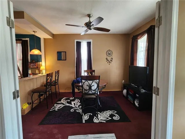 a living room with furniture rug and window