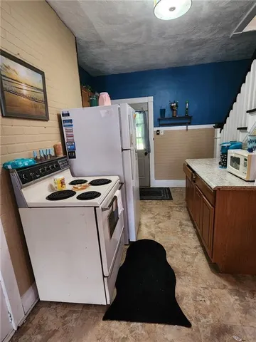 a kitchen with a stove and a refrigerator