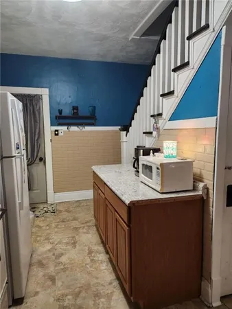 a kitchen with a refrigerator and a stove