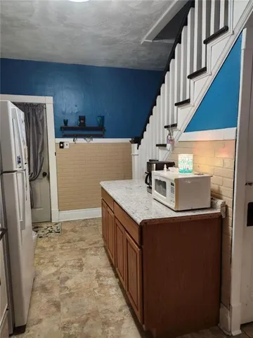 a kitchen with a refrigerator and a stove