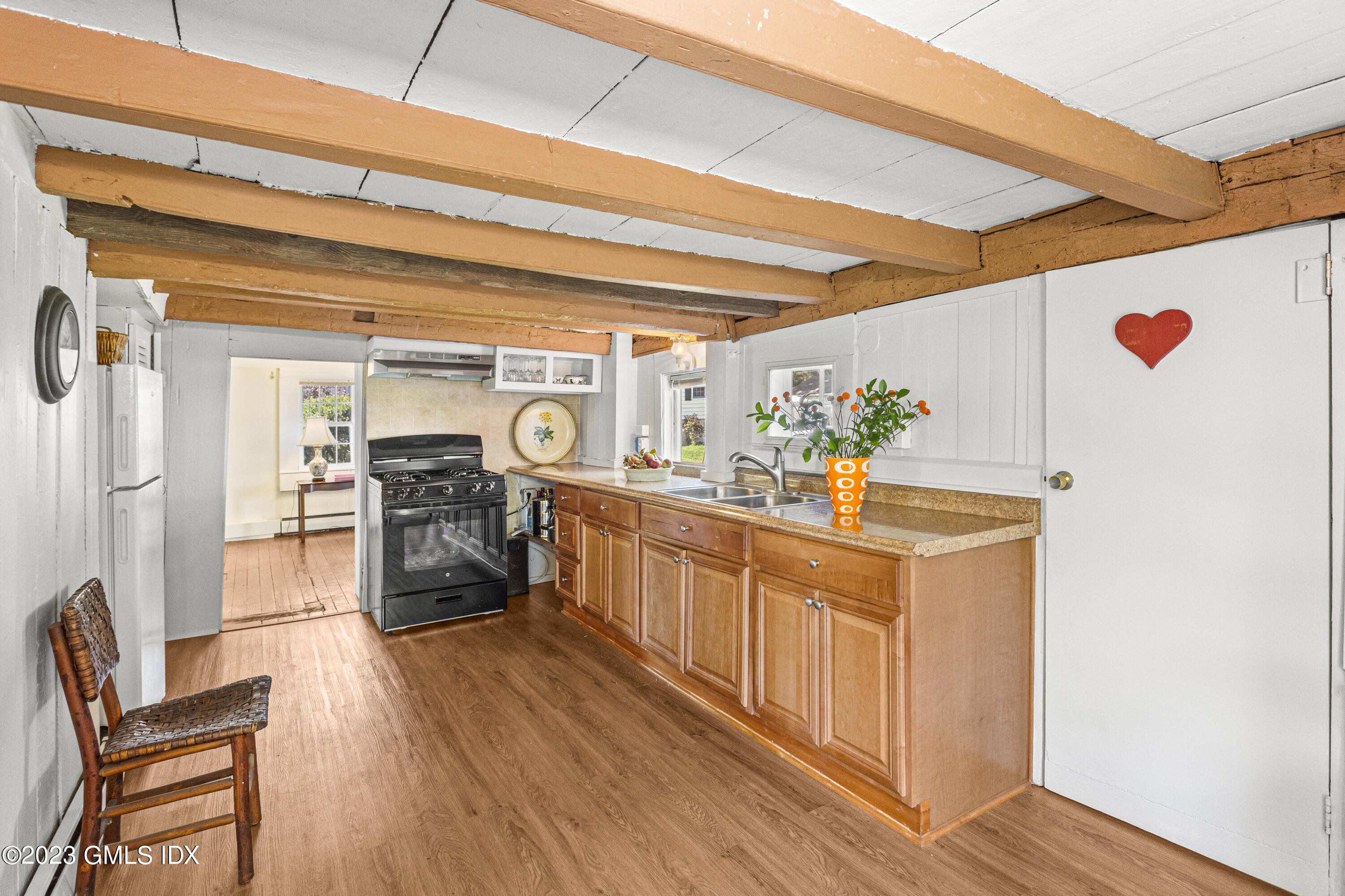 1 Cary Road Riverside, CT 06878 - Photo 8 of 15 a kitchen with stainless steel appliances kitchen island granite countertop a table chairs in it and wooden floors