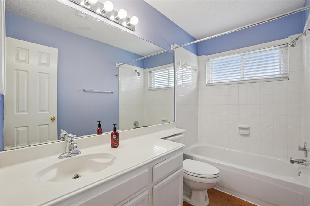 3110 Andrew Lane Carrollton, TX 75007 - Photo 20 of 36 a bathroom with a sink a toilet and a large mirror