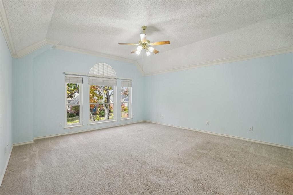 3110 Andrew Lane Carrollton, TX 75007 - Photo 23 of 36 an empty room with windows and chandelier fan