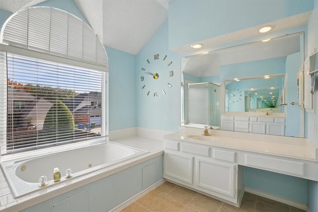 3110 Andrew Lane Carrollton, TX 75007 - Photo 27 of 36 a bathroom with a granite countertop tub sink and mirror