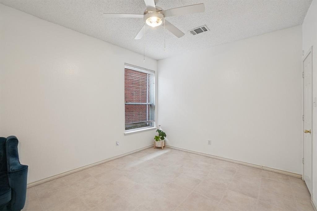 3110 Andrew Lane Carrollton, TX 75007 - Photo 28 of 36 an empty room with a ceiling fan and a window