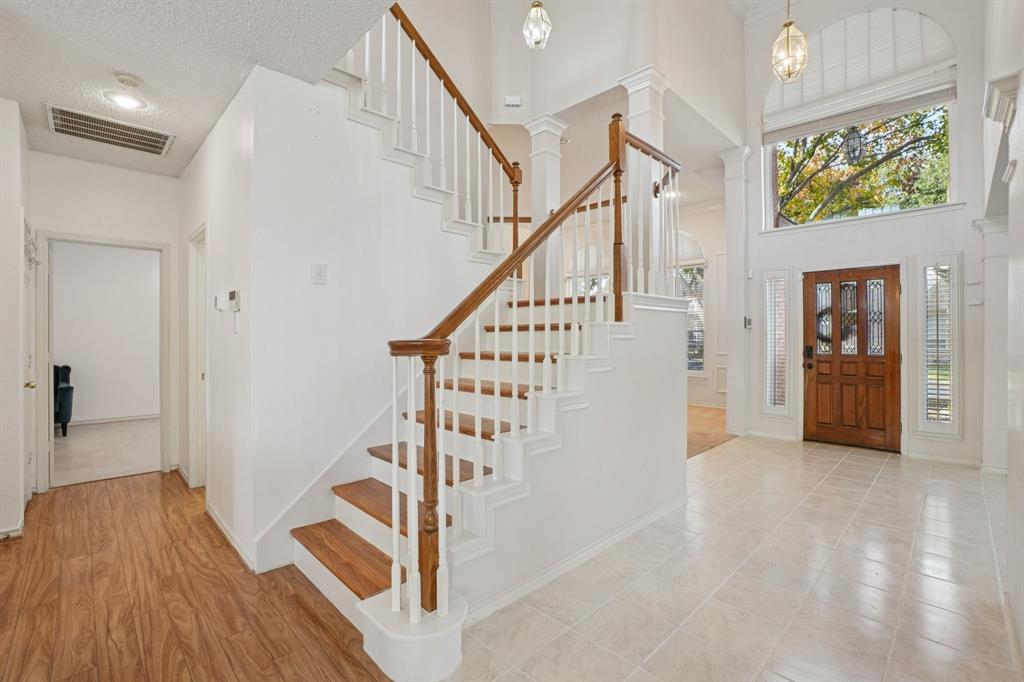 3110 Andrew Lane Carrollton, TX 75007 - Photo 4 of 36 a view of entryway with wooden floor and stairs
