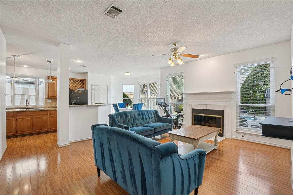 3110 Andrew Lane Carrollton, TX 75007 - Photo 5 of 36 a living room with furniture and a fireplace