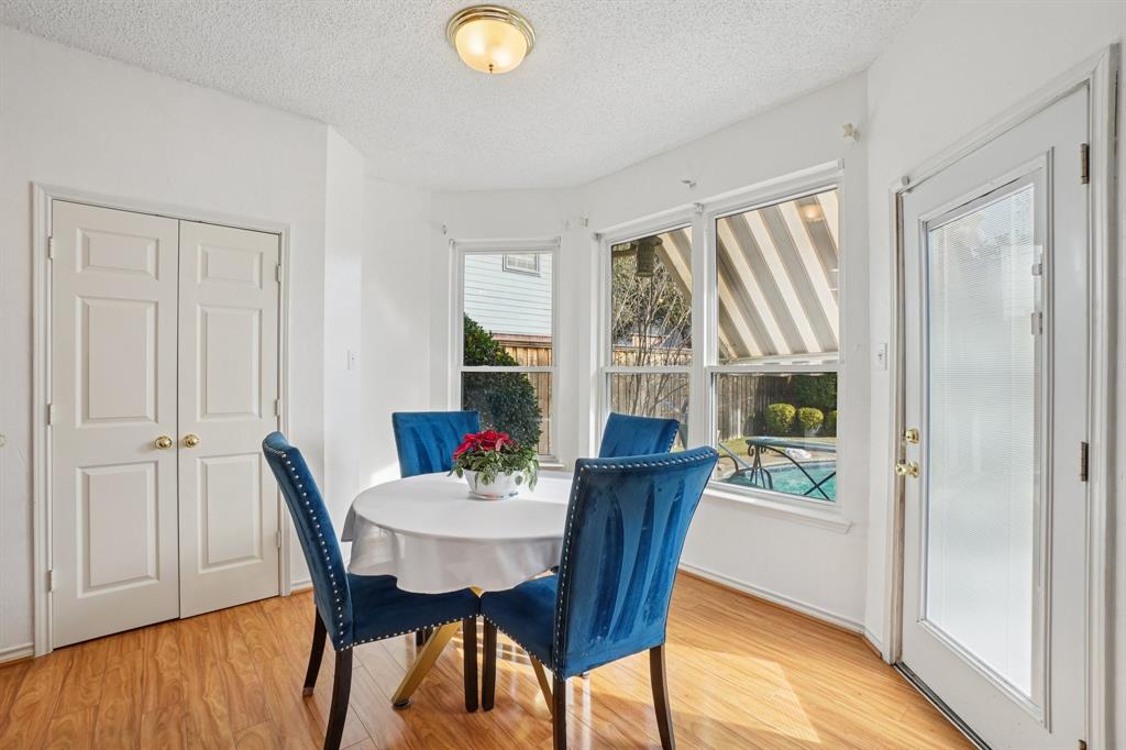 3110 Andrew Lane Carrollton, TX 75007 - Photo 7 of 36 a view of a dining room with furniture and wooden floor