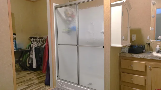 a view of walk in closet with clothes