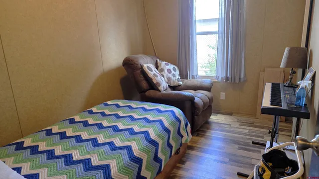 a bedroom with a bed and a window