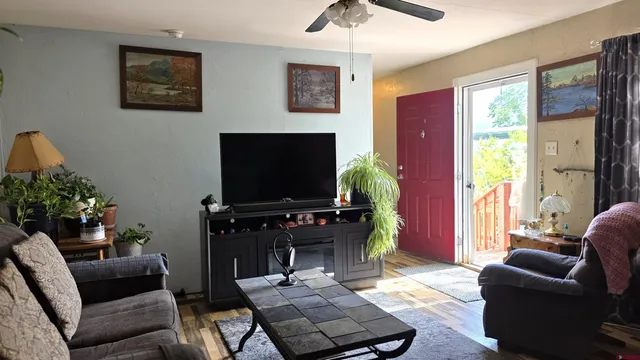 a living room with furniture and a flat screen tv