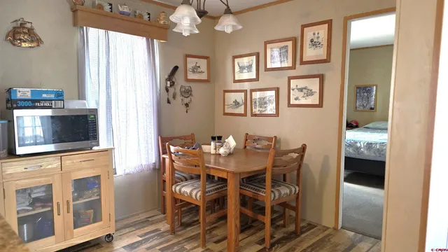 a view of a dining room with furniture and chandelier