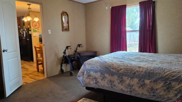 a bedroom with a bed and a mirror