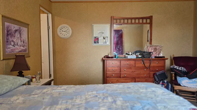 a bedroom with a bed and a table in it