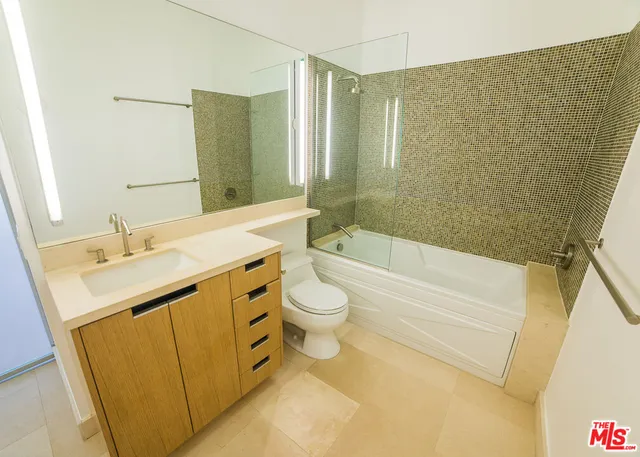 a bathroom with a sink toilet and mirror