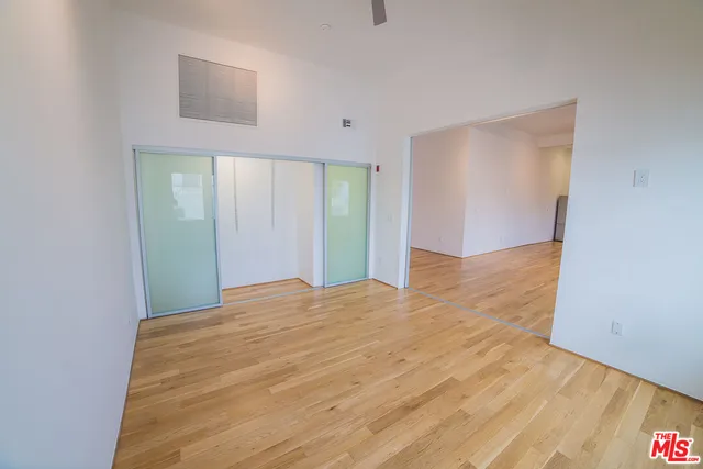a view of empty room with wooden floor