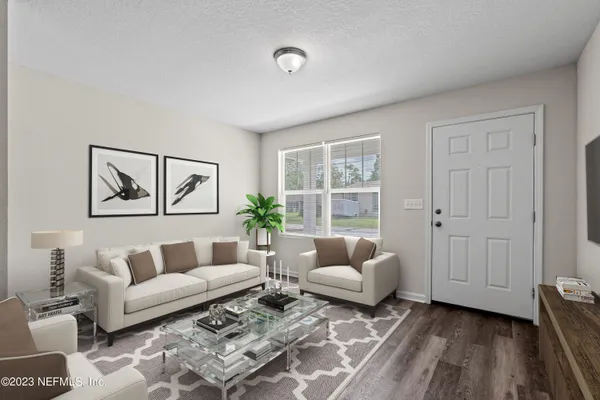 a living room with furniture and wooden floor