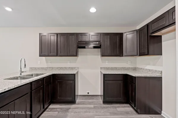 a kitchen with stainless steel appliances granite countertop a refrigerator and a sink