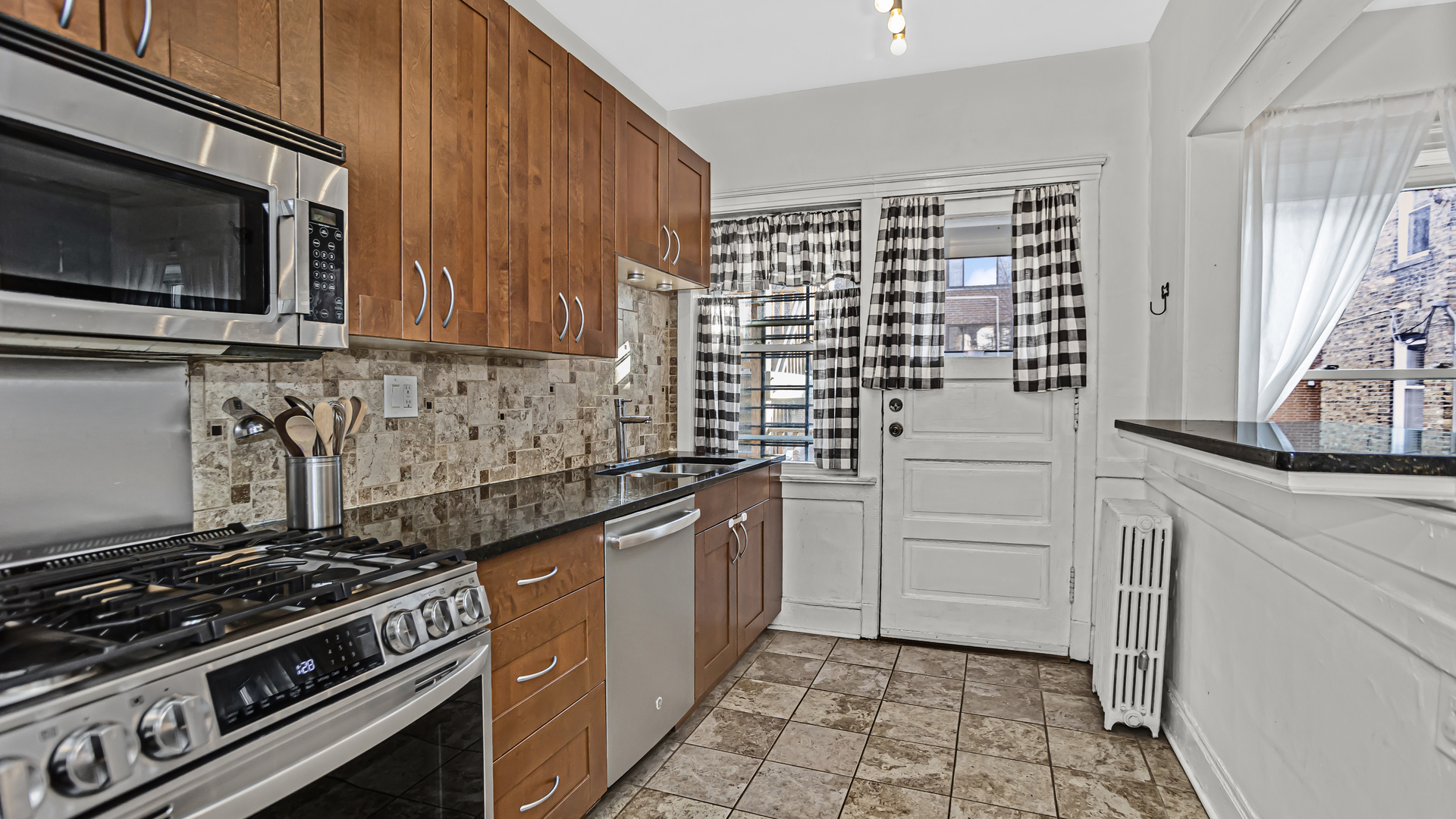 322 Main Street, Unit 2 Evanston, IL 60202 - Photo 5 of 15 a kitchen with granite countertop a stove and a sink