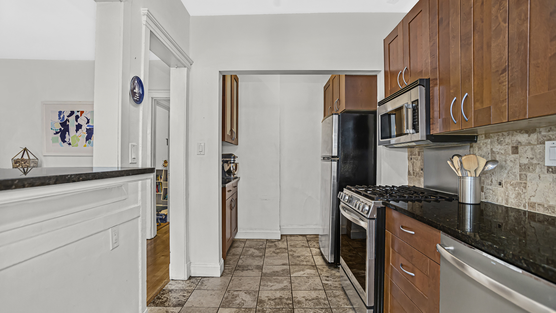 322 Main Street, Unit 2 Evanston, IL 60202 - Photo 6 of 15 a kitchen with stainless steel appliances granite countertop a refrigerator and a sink