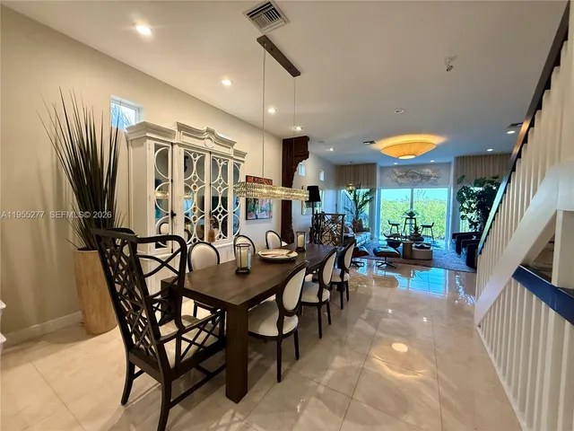 a living room with furniture a chandelier and a chandelier
