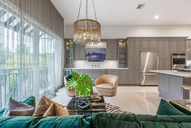 a living room with furniture and kitchen view