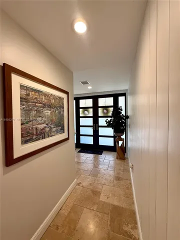 a view of a hallway with stairs