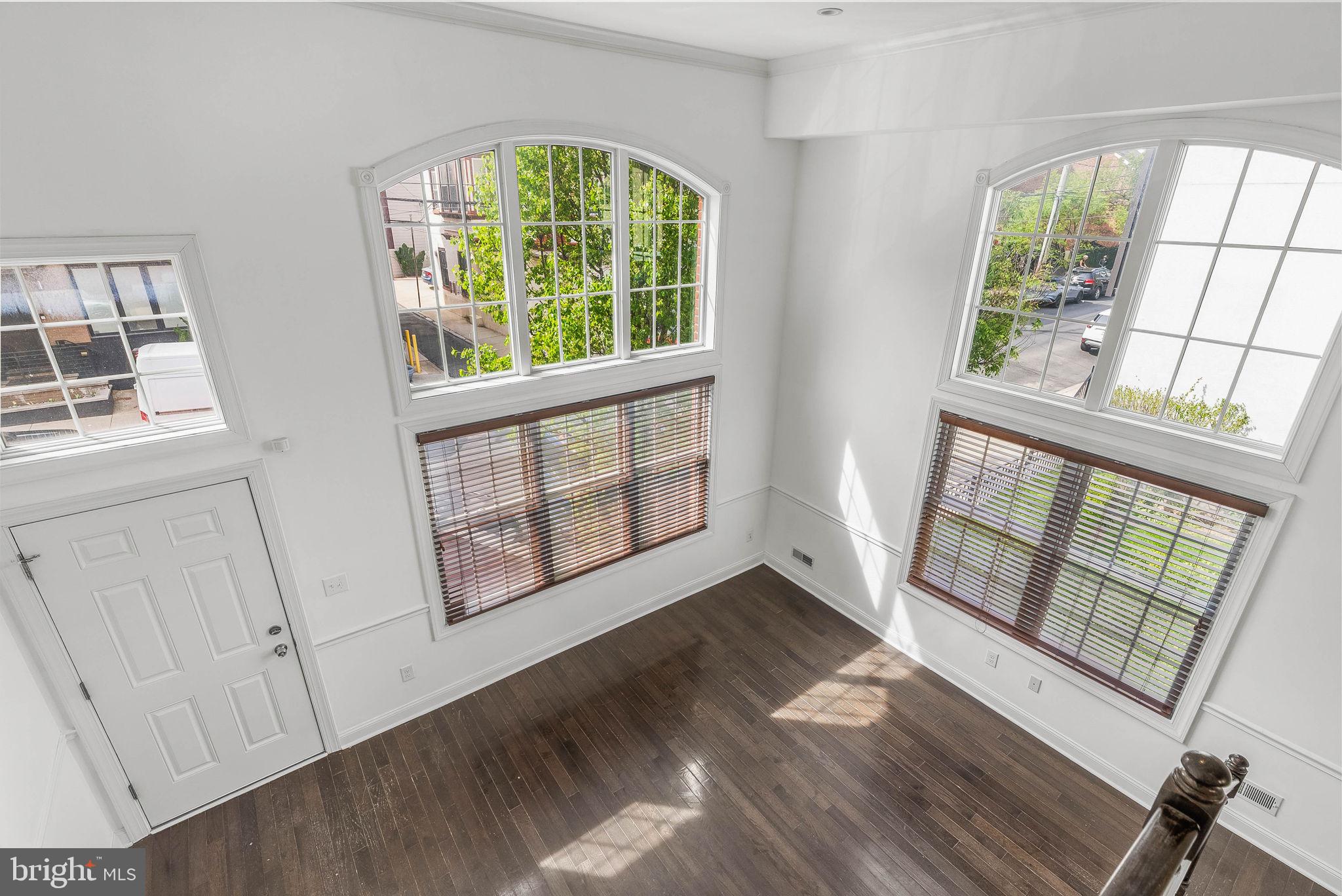 1015 North 3rd Street, Unit H Philadelphia, PA 19123 - Photo 3 of 27 wooden floor in an empty room with a window