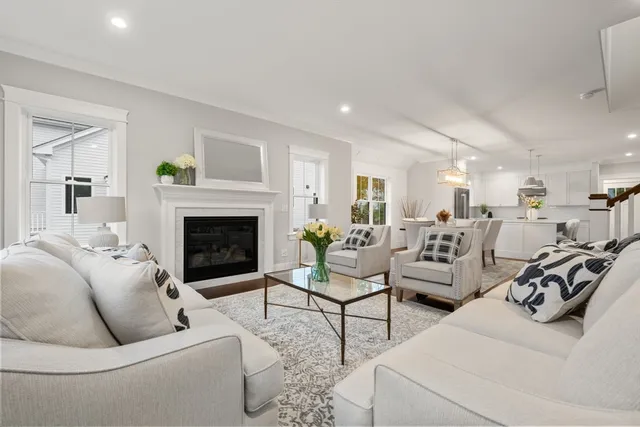 a living room with furniture a fireplace and a table