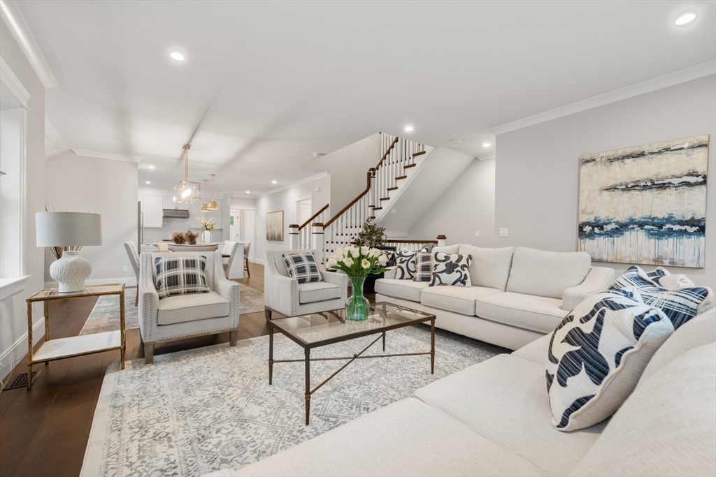 16 Wayside Road, Unit 14 Natick, MA 01760 - Photo 13 of 42 a living room with furniture and a chandelier