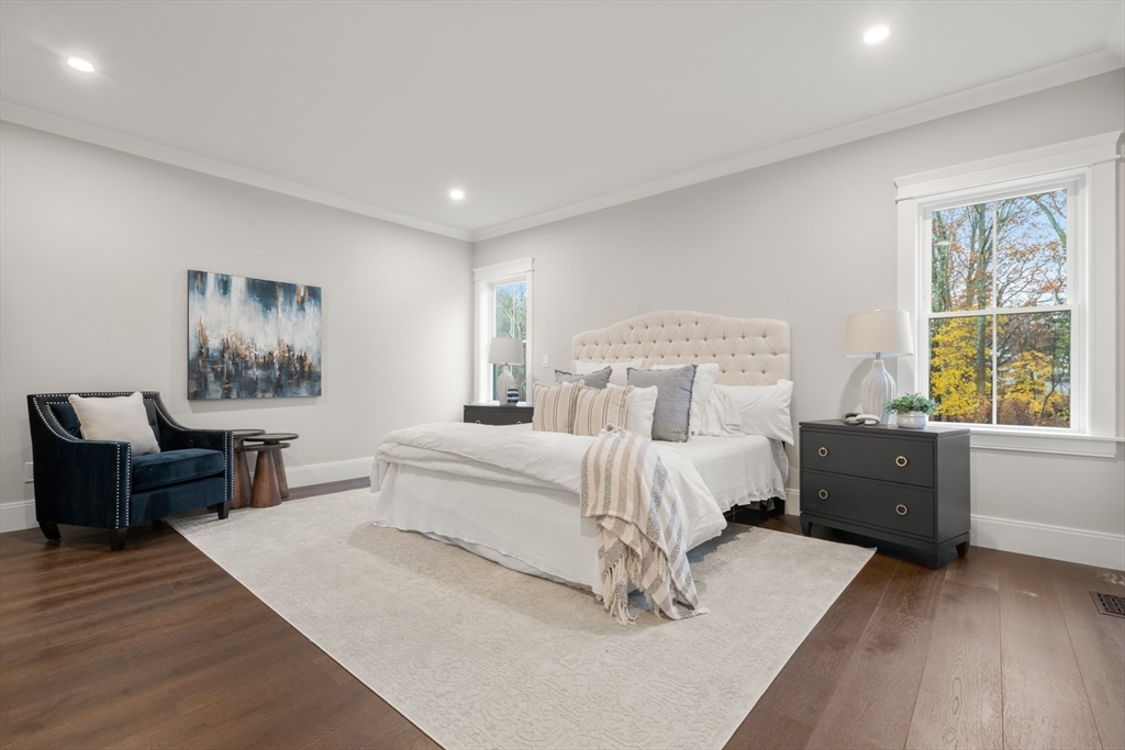 16 Wayside Road, Unit 14 Natick, MA 01760 - Photo 14 of 42 a bedroom with a bed and a table