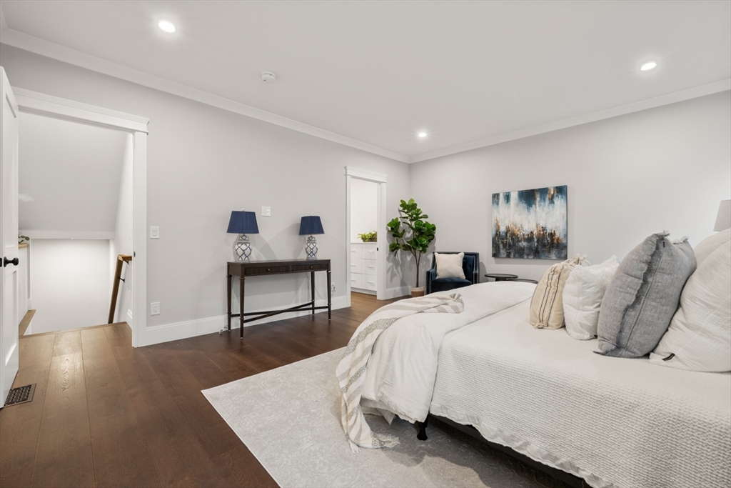16 Wayside Road, Unit 14 Natick, MA 01760 - Photo 16 of 42 a spacious bedroom with a bed and a view of kitchen
