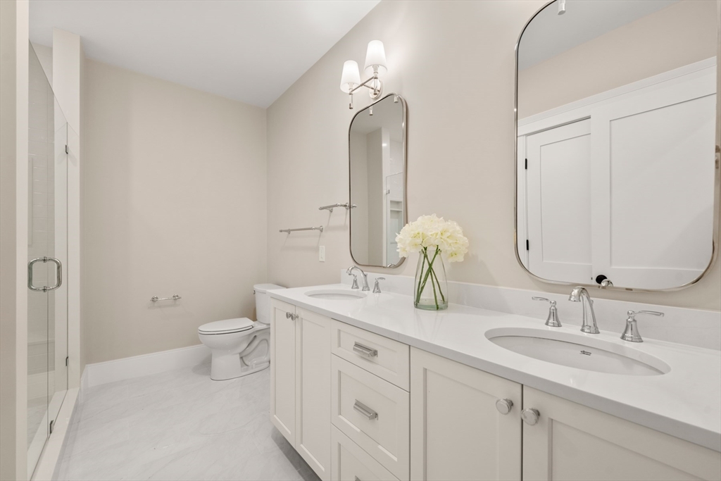 16 Wayside Road, Unit 14 Natick, MA 01760 - Photo 18 of 42 a bathroom with a toilet sink and mirror