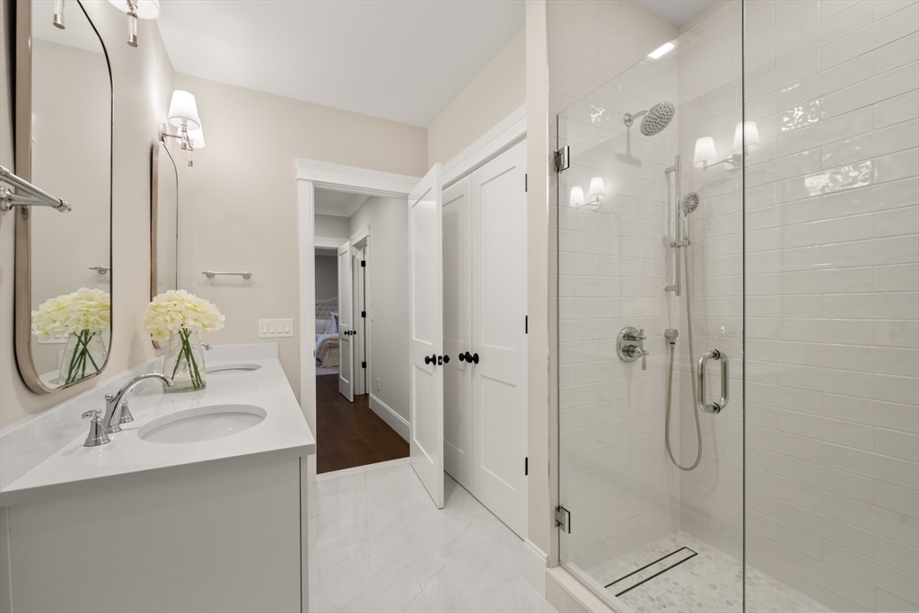 16 Wayside Road, Unit 14 Natick, MA 01760 - Photo 19 of 42 a bathroom with a double vanity sink mirror and shower