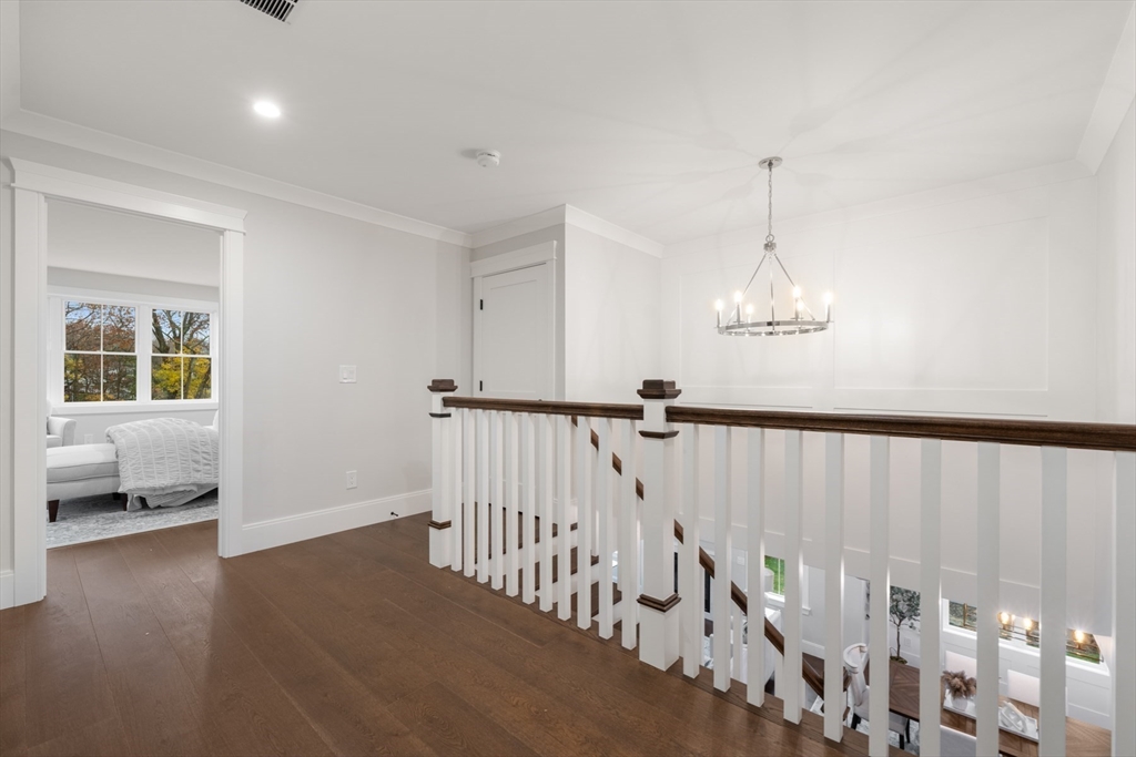 16 Wayside Road, Unit 14 Natick, MA 01760 - Photo 25 of 42 a view of staircase with white walls and wooden floor