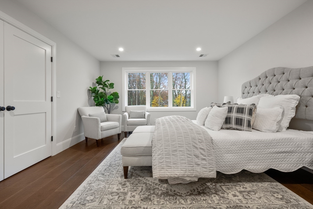16 Wayside Road, Unit 14 Natick, MA 01760 - Photo 26 of 42 a bedroom with a bed and wooden floor